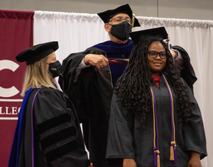 MBA graduate Chinaza Nwosa, Lagos, Nigeria, is hooded by Dr. Rick Koza
