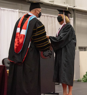 Chadron State College President Dr. Randy Rhine, left, congratulates Celeste Lee