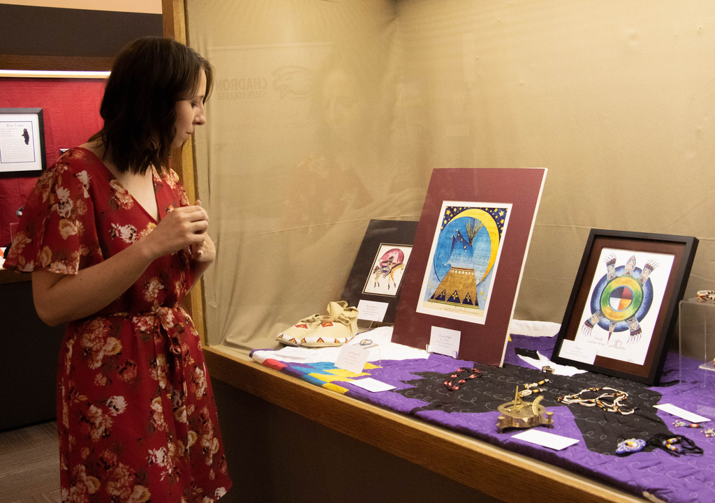 Dallas Magnusson, accounting clerk II, views Lakota cultural items on display in the Mari Sandoz High Plains Heritage Center as part of Kapemni