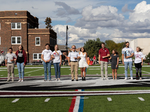 The homecoming attendants line up on Elliot Field for practice.