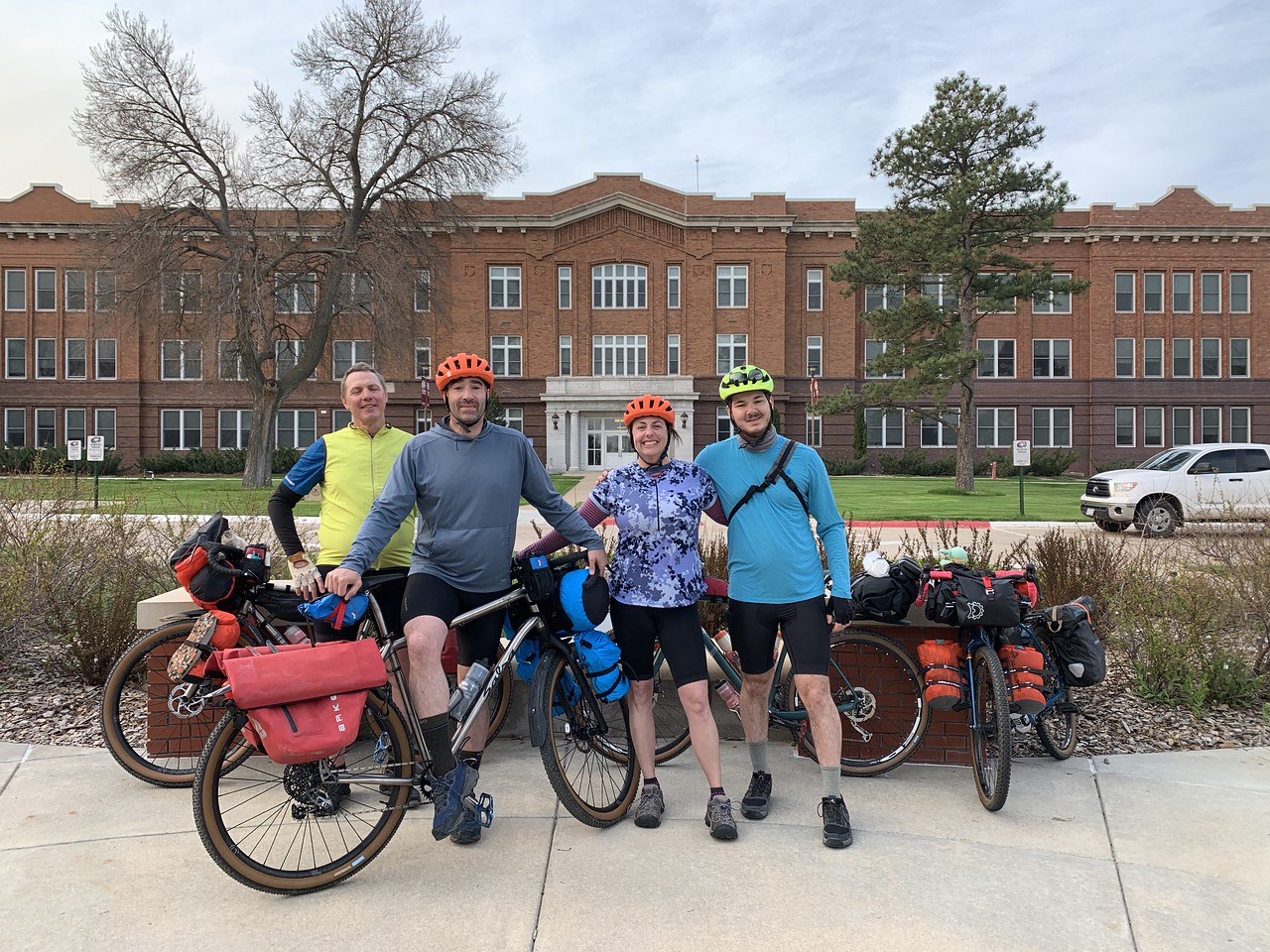 A group of people posing with bicycles
