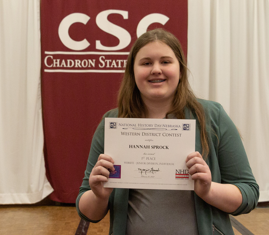 One high school student poses with her award as CSC hosts History Day