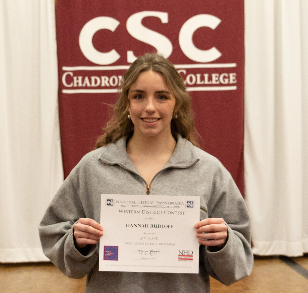 One high school student poses with her award as CSC hosts History Day