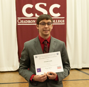 One high school student poses with his award as CSC hosts History Day.