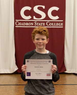 One high school student poses with his award as CSC hosts History Day.