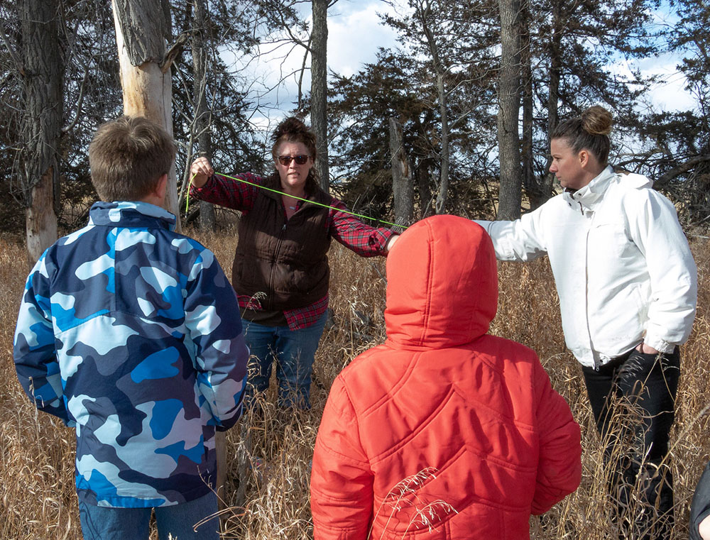 Adults setting up bait for wildlife camera trap