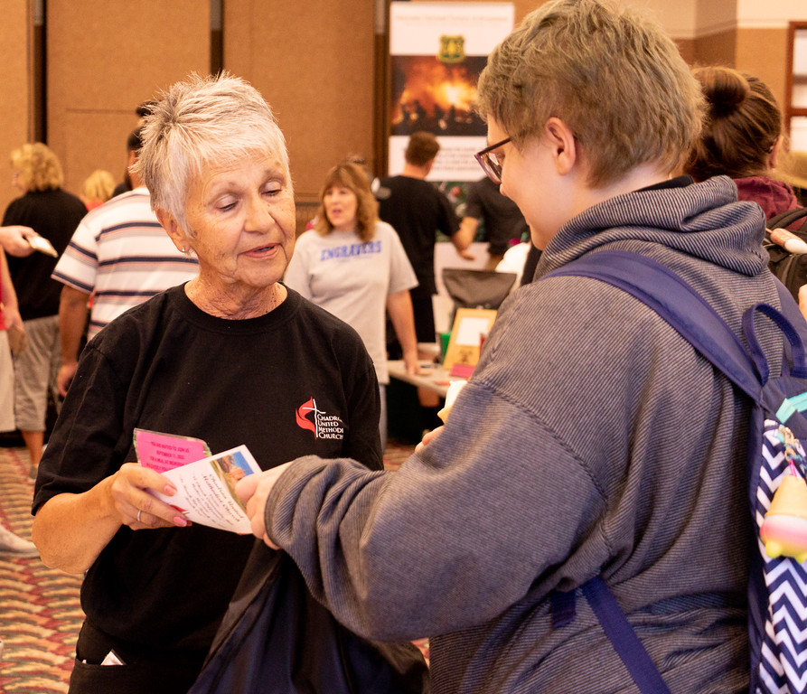 Community volunteer speaking to a student