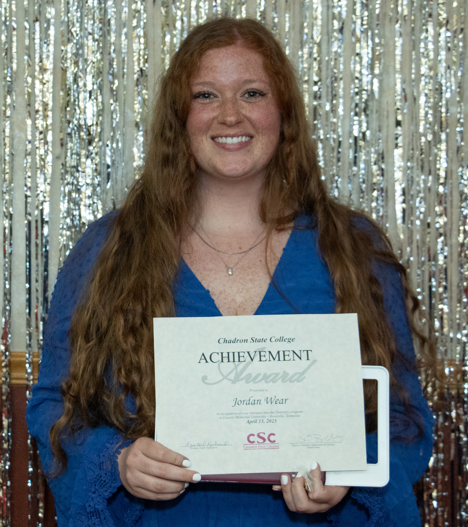 Person standing with an award