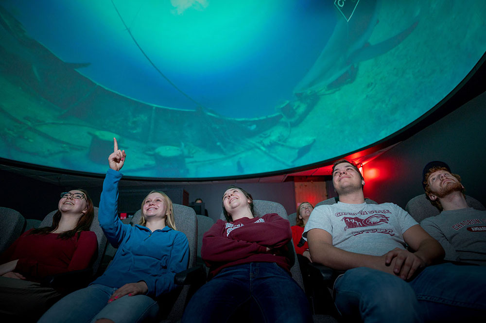 Students seated in planetarium