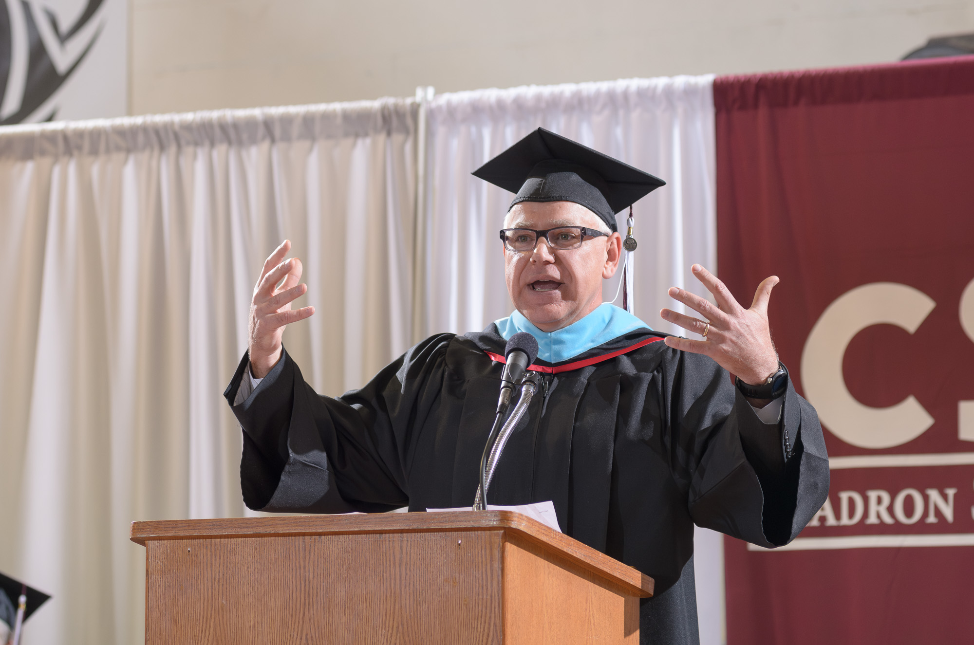 Male adult speaking at a podium