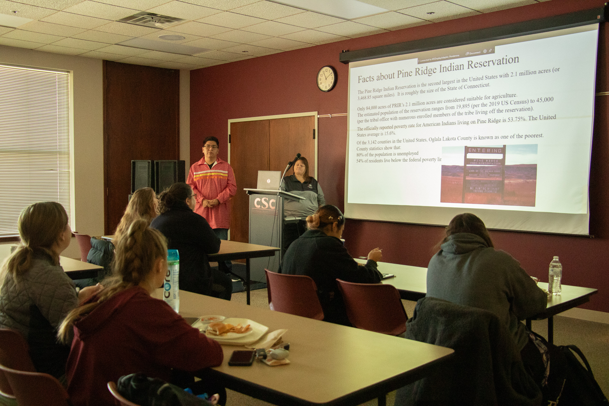 Two adults making a presentation to an audience