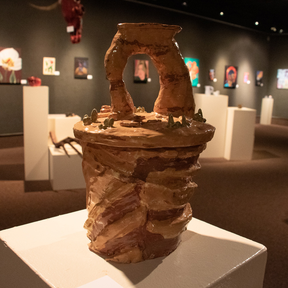Ceramics and paintings in a gallery