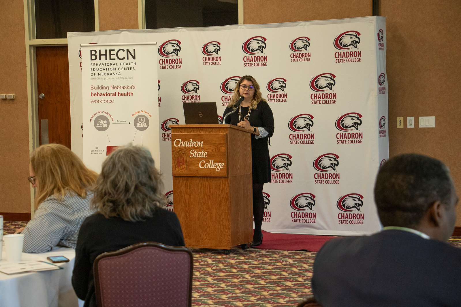 Woman speaking to an audience from a podium in the Student Center