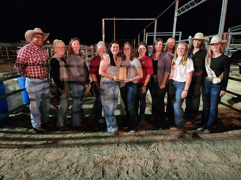 Group of adults standing in a rodeo arena