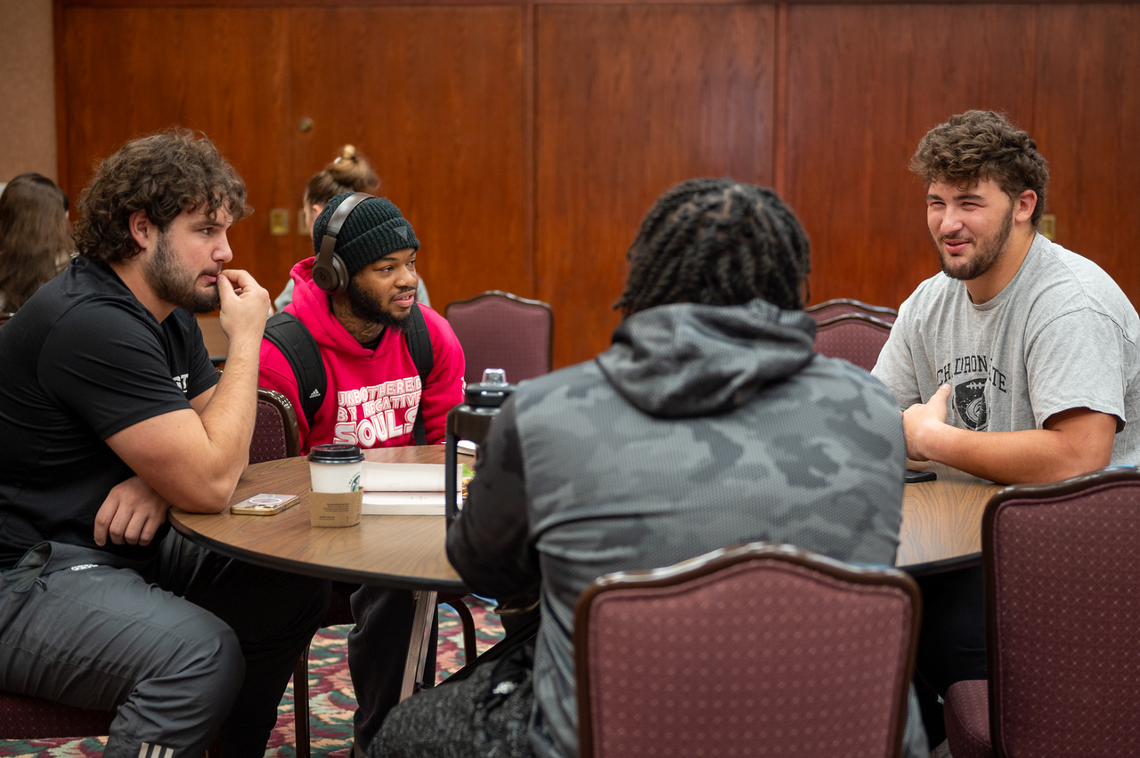 Students talking around a table