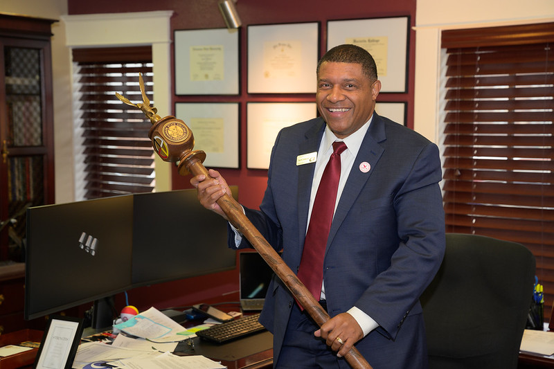 Adult male holding a ceremonial mace