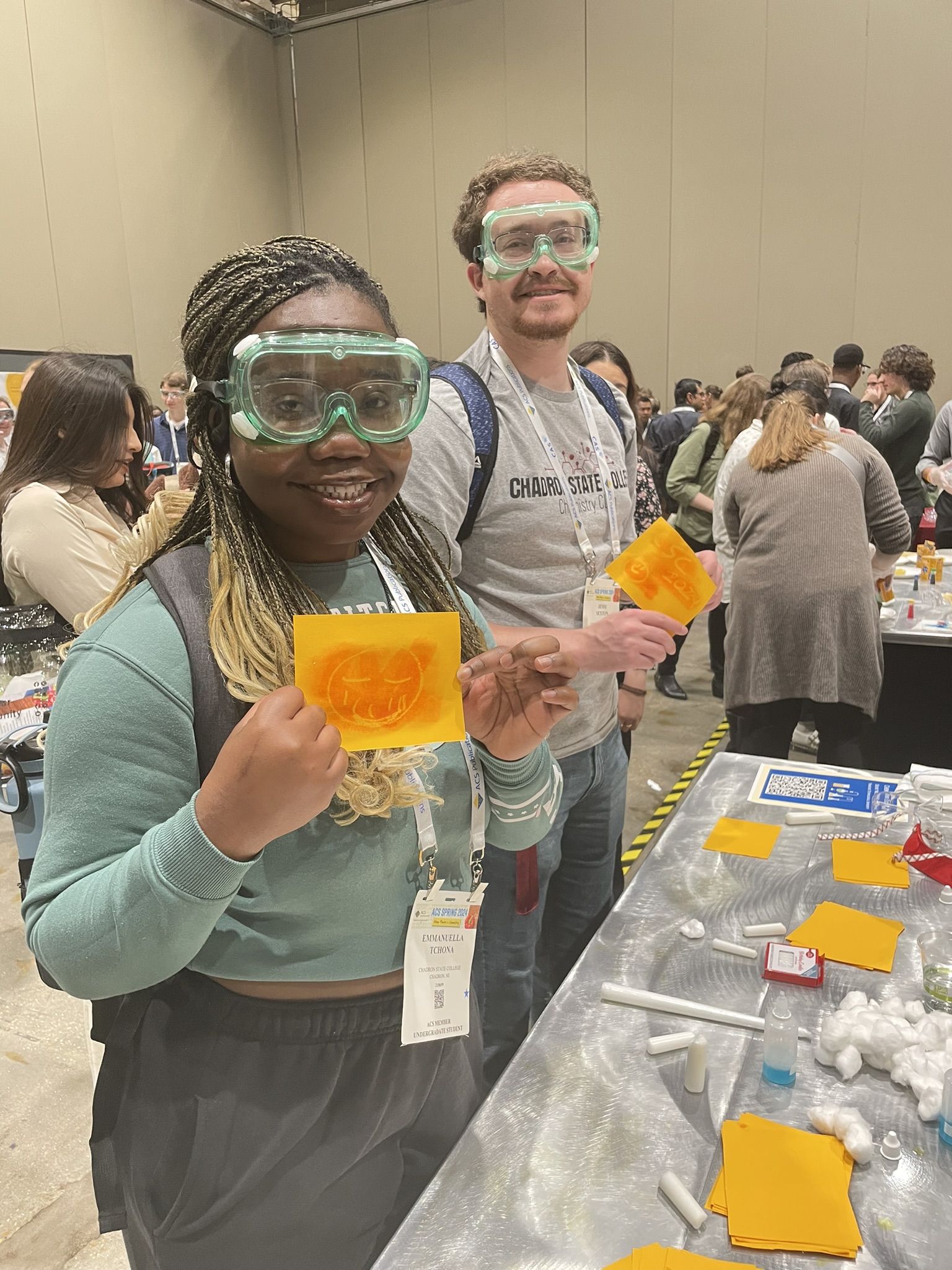 Two students posing in a chemistry lab setting