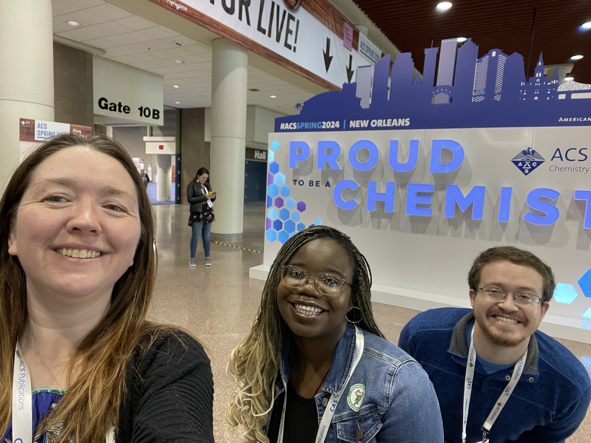 Three adults posing at a national conference