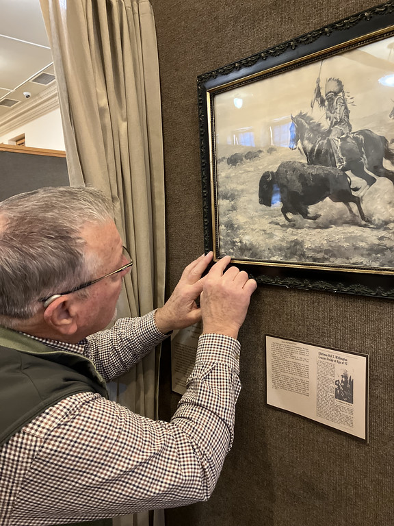 Man with art in an exhibit
