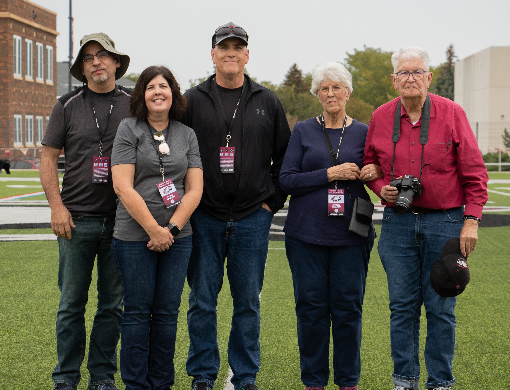 Group of adults posing on a football field