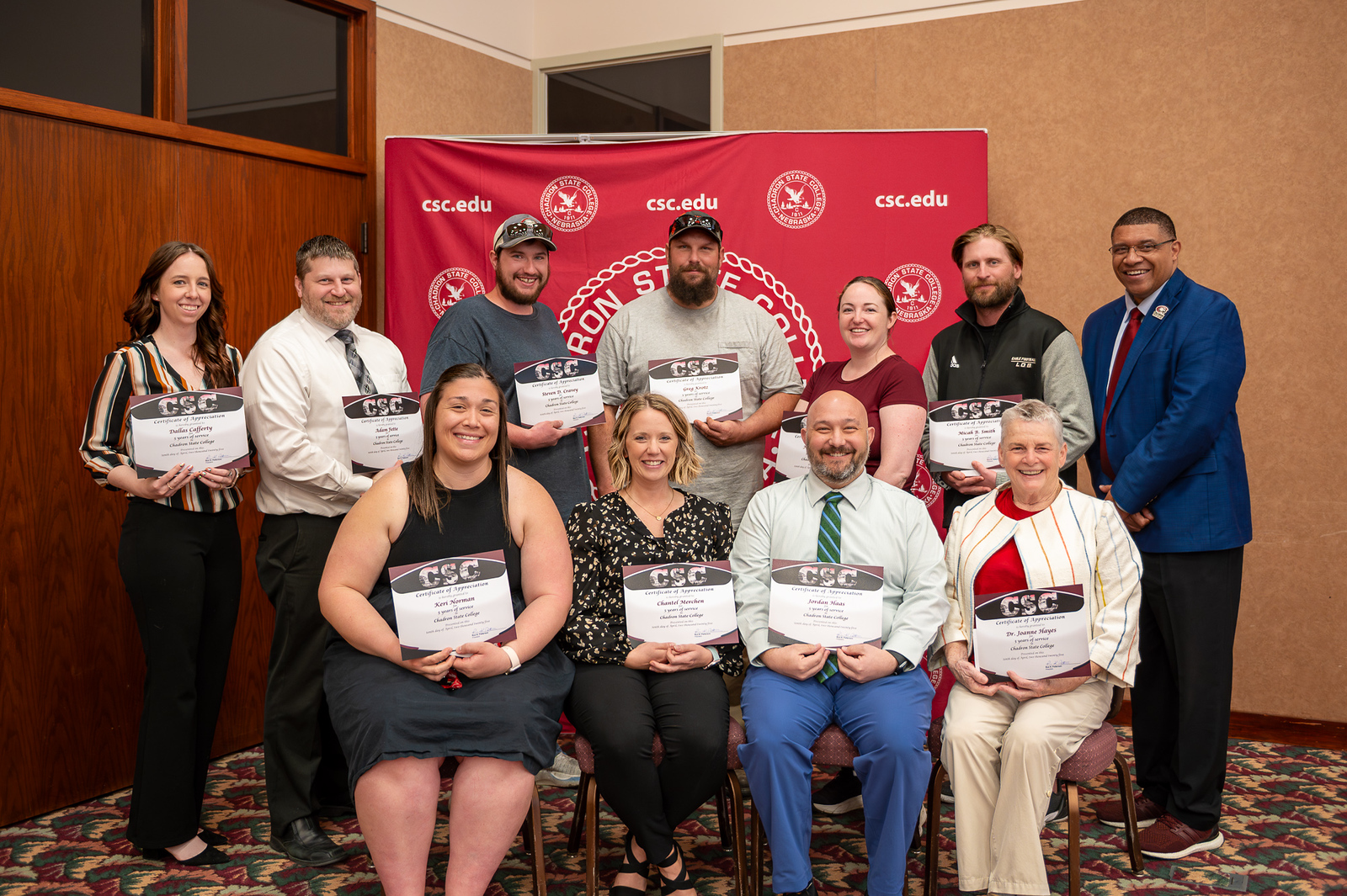 Group of adults posing with awards