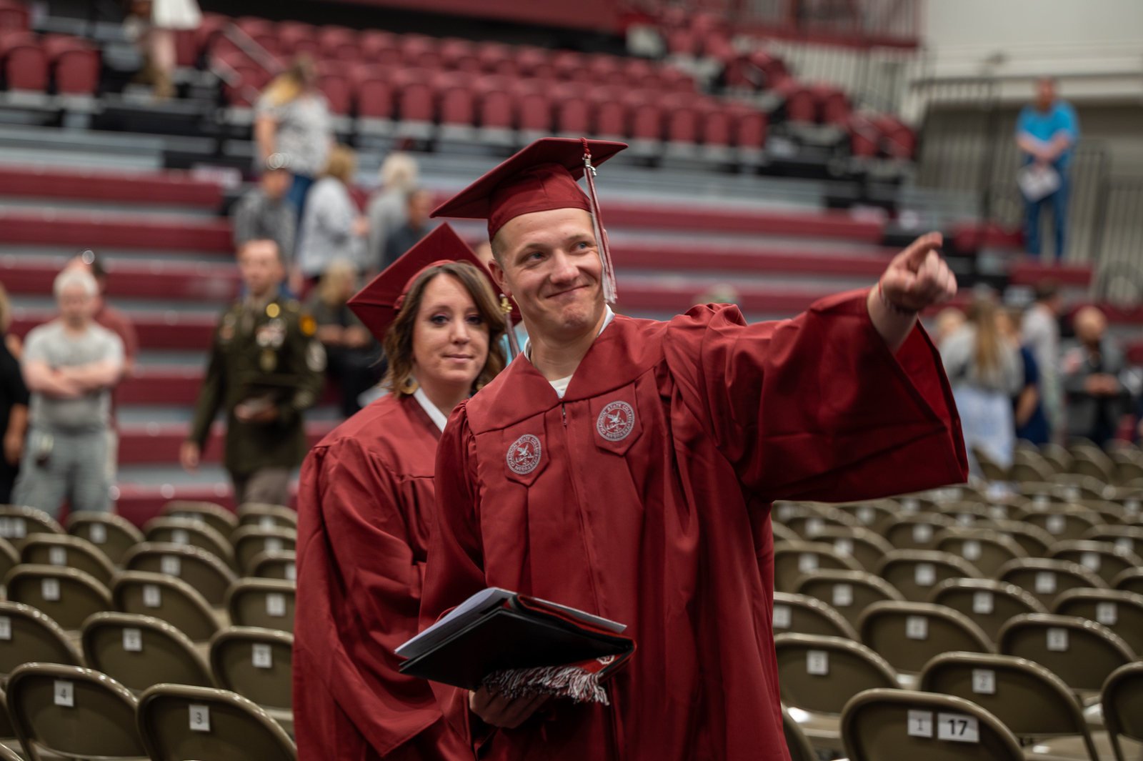Two graduates in gowns at commencement