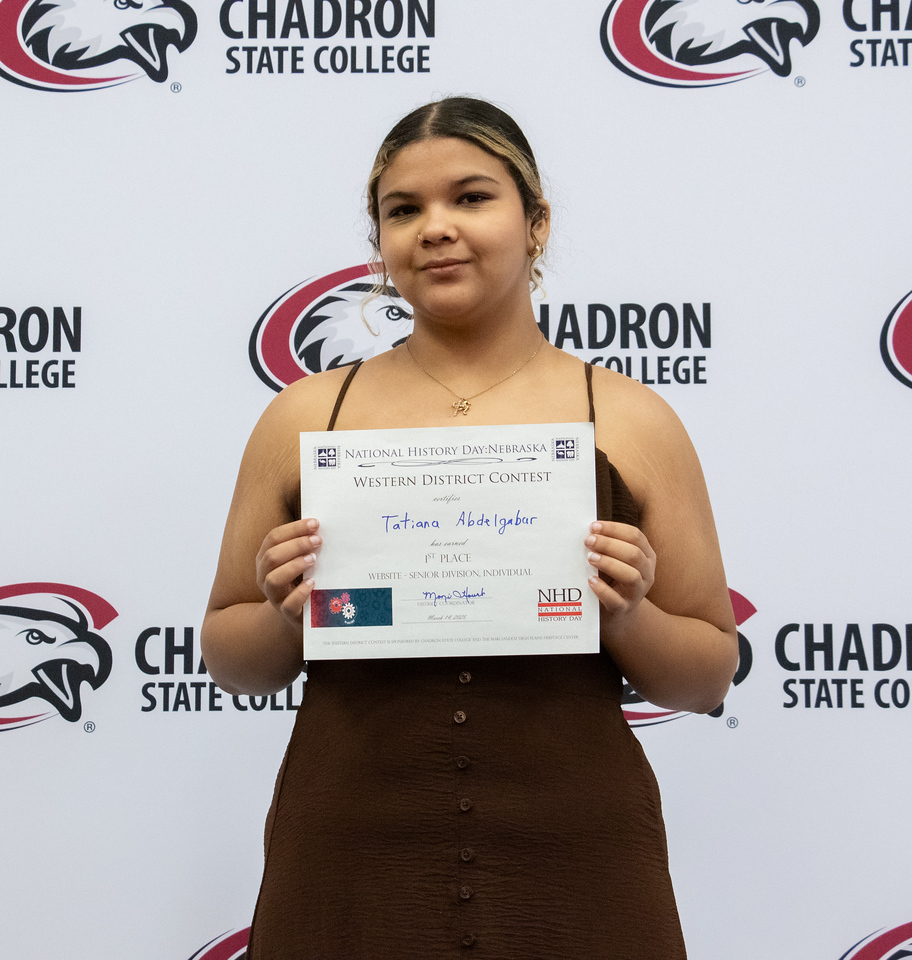 Student posing with a certificate