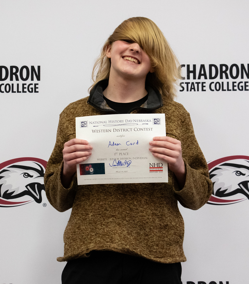 Student posing with a certificate