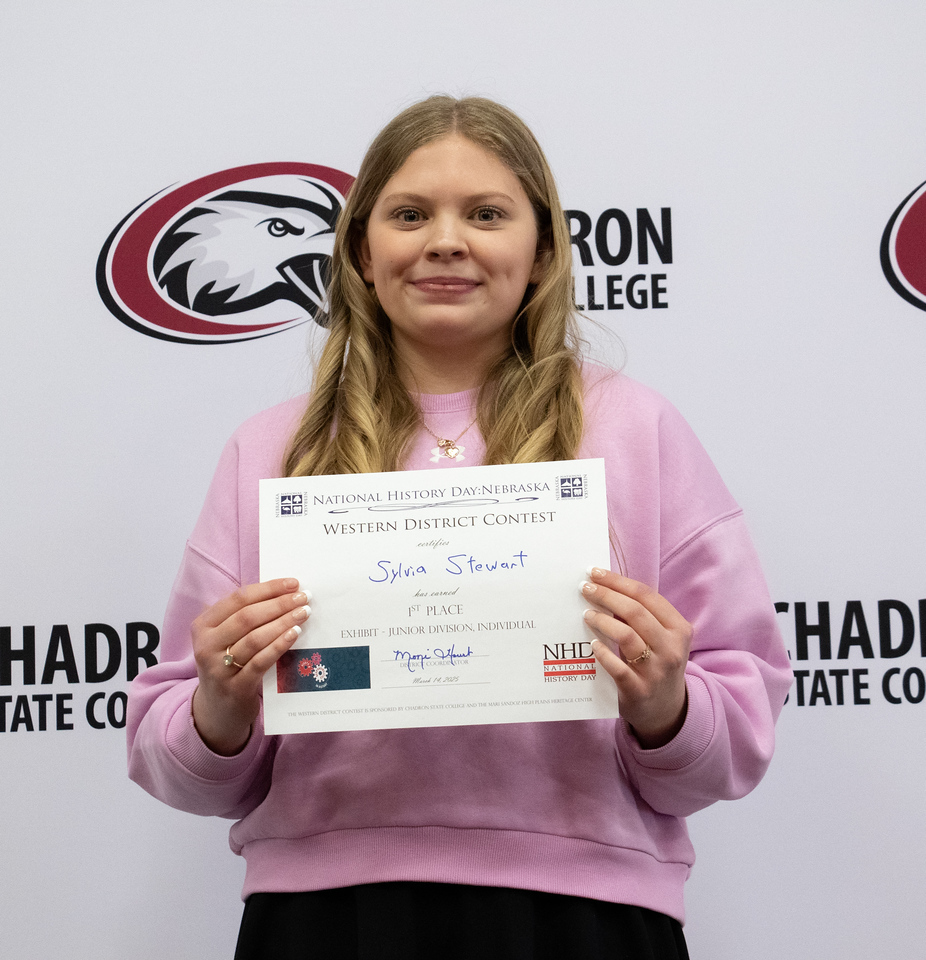 Student posing with a certificate