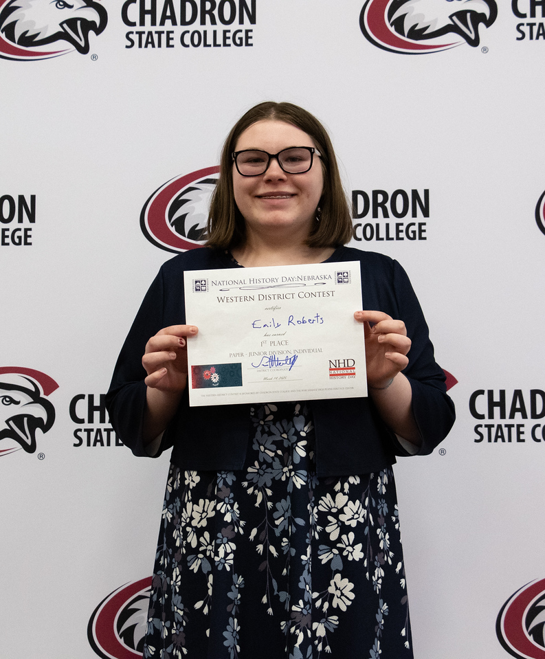 Student posing with a certificate