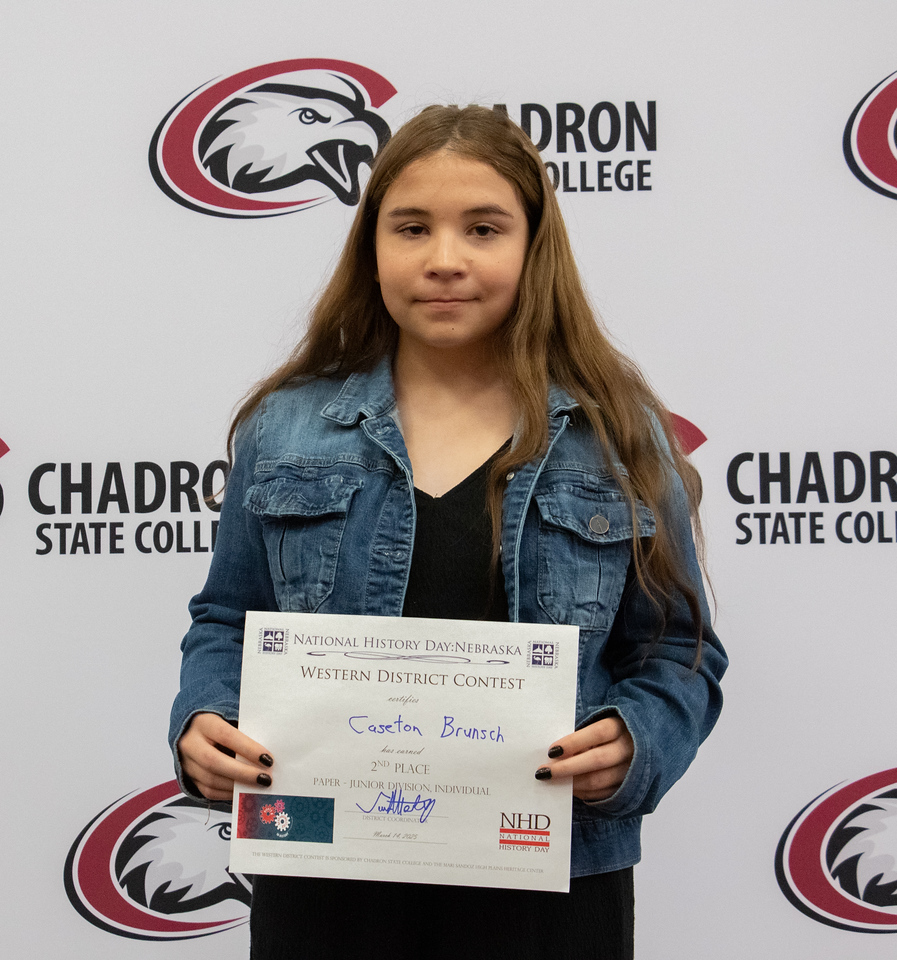 Student posing with a certificate