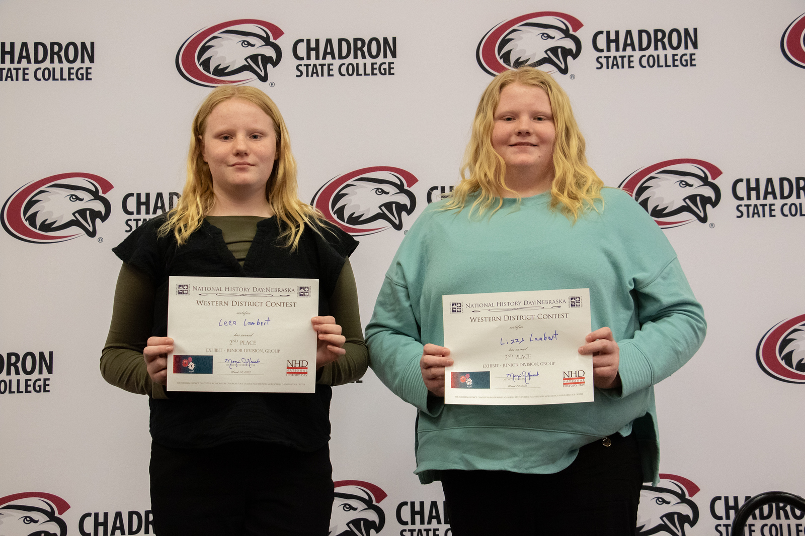 Students posing with certificates