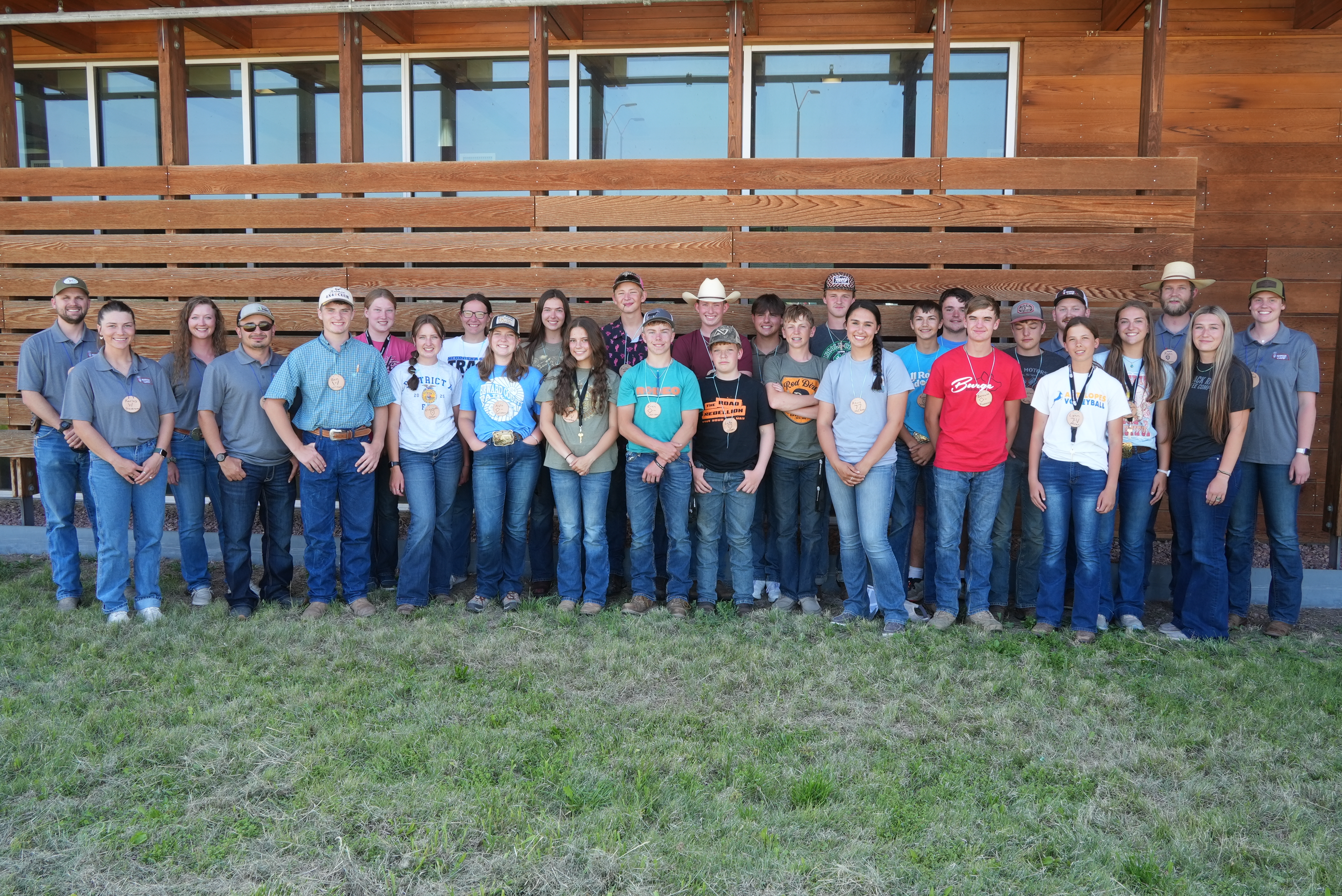 Students posing outside by the range building
