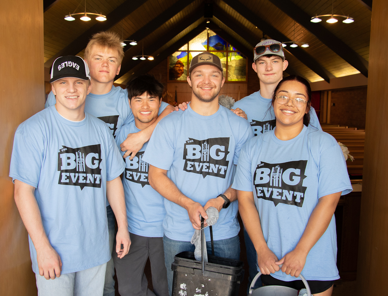 Group of student volunteers posing in a church