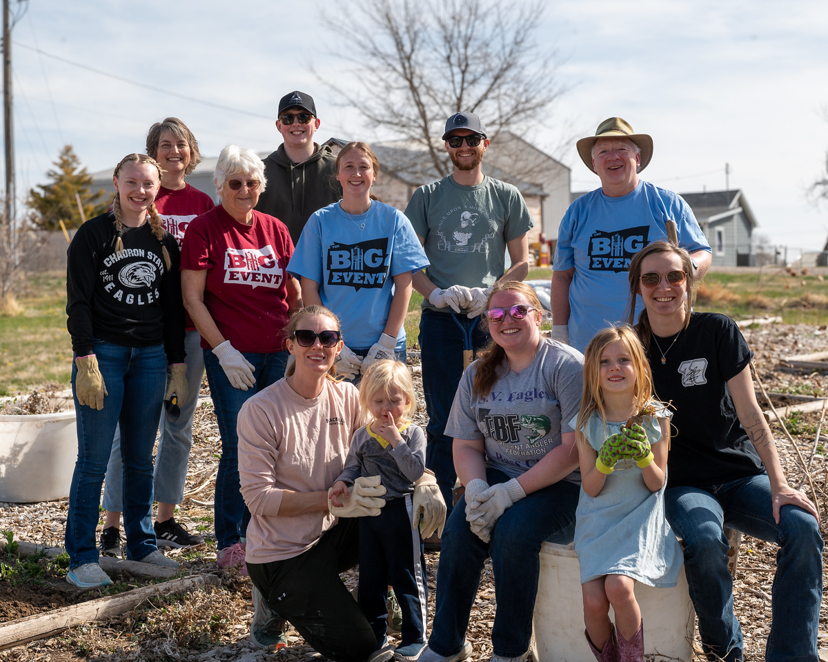 Group of adults and children posing in a school garden