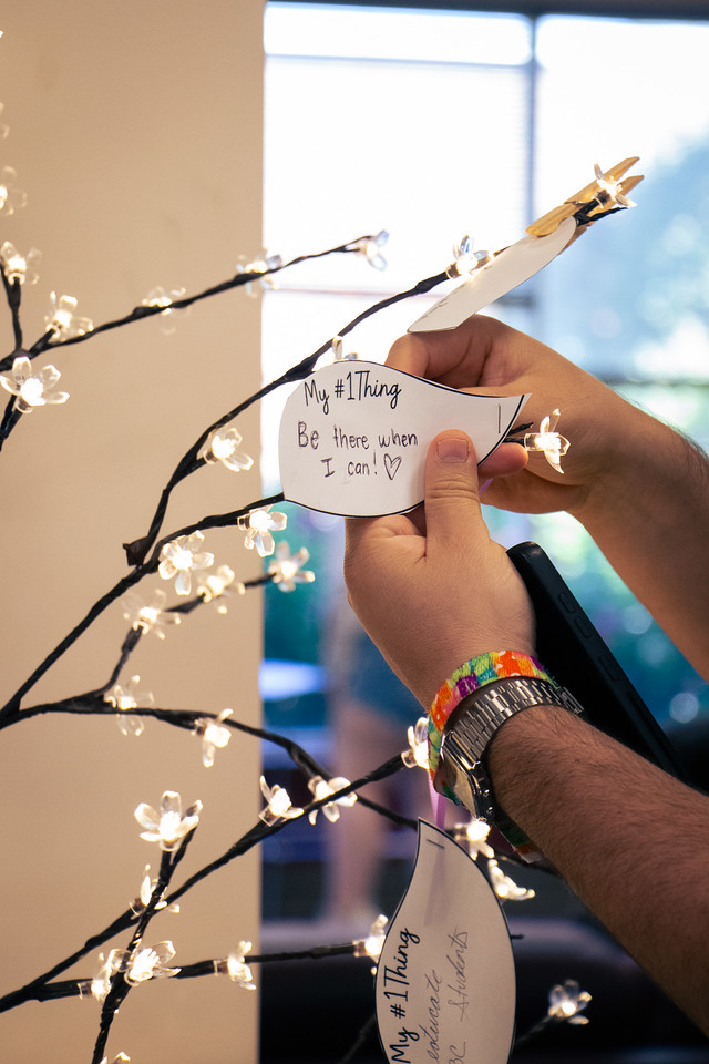 Close-up of hand placing a message on a tree