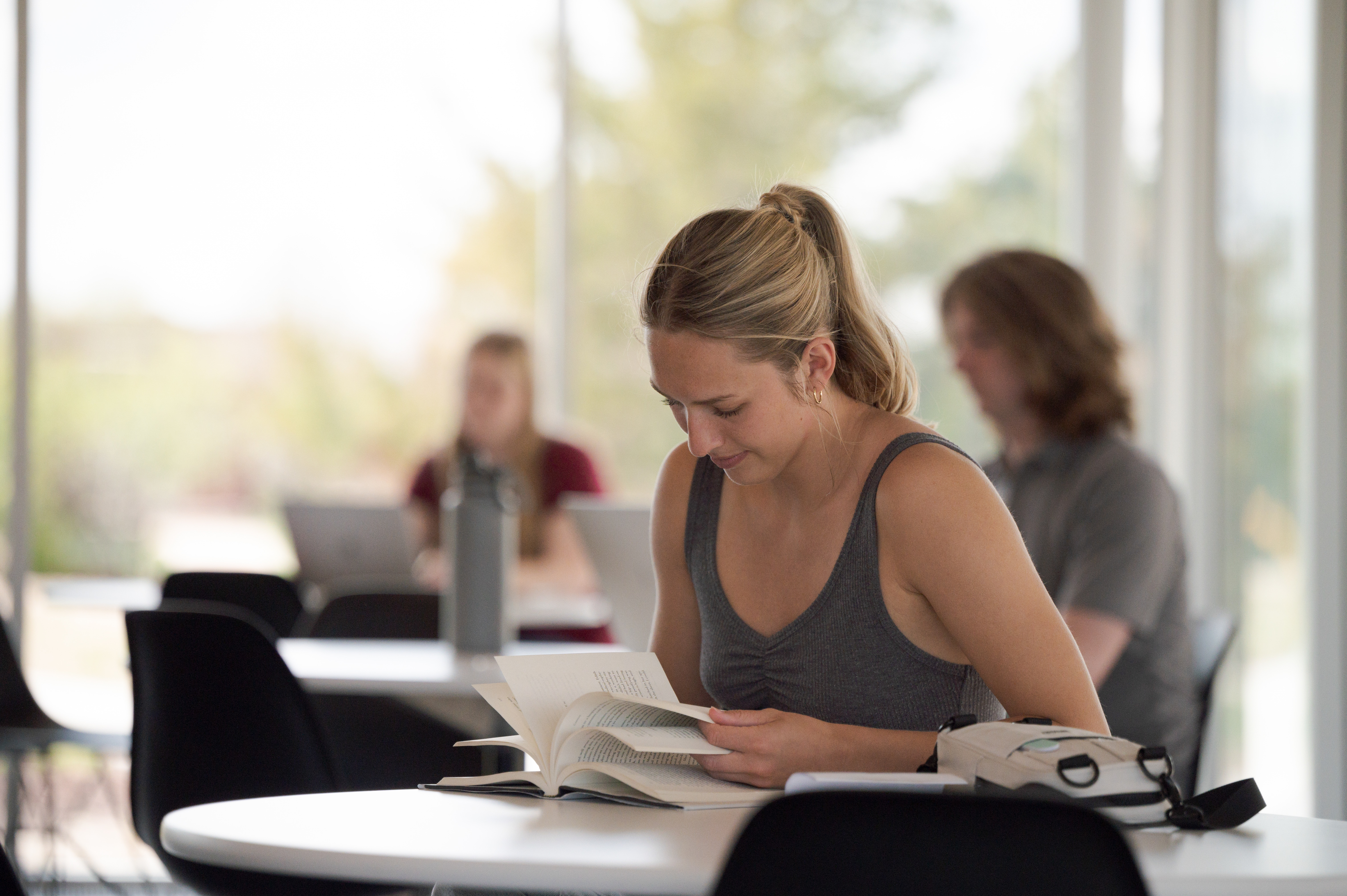 A student flipping to a page in her textbook.