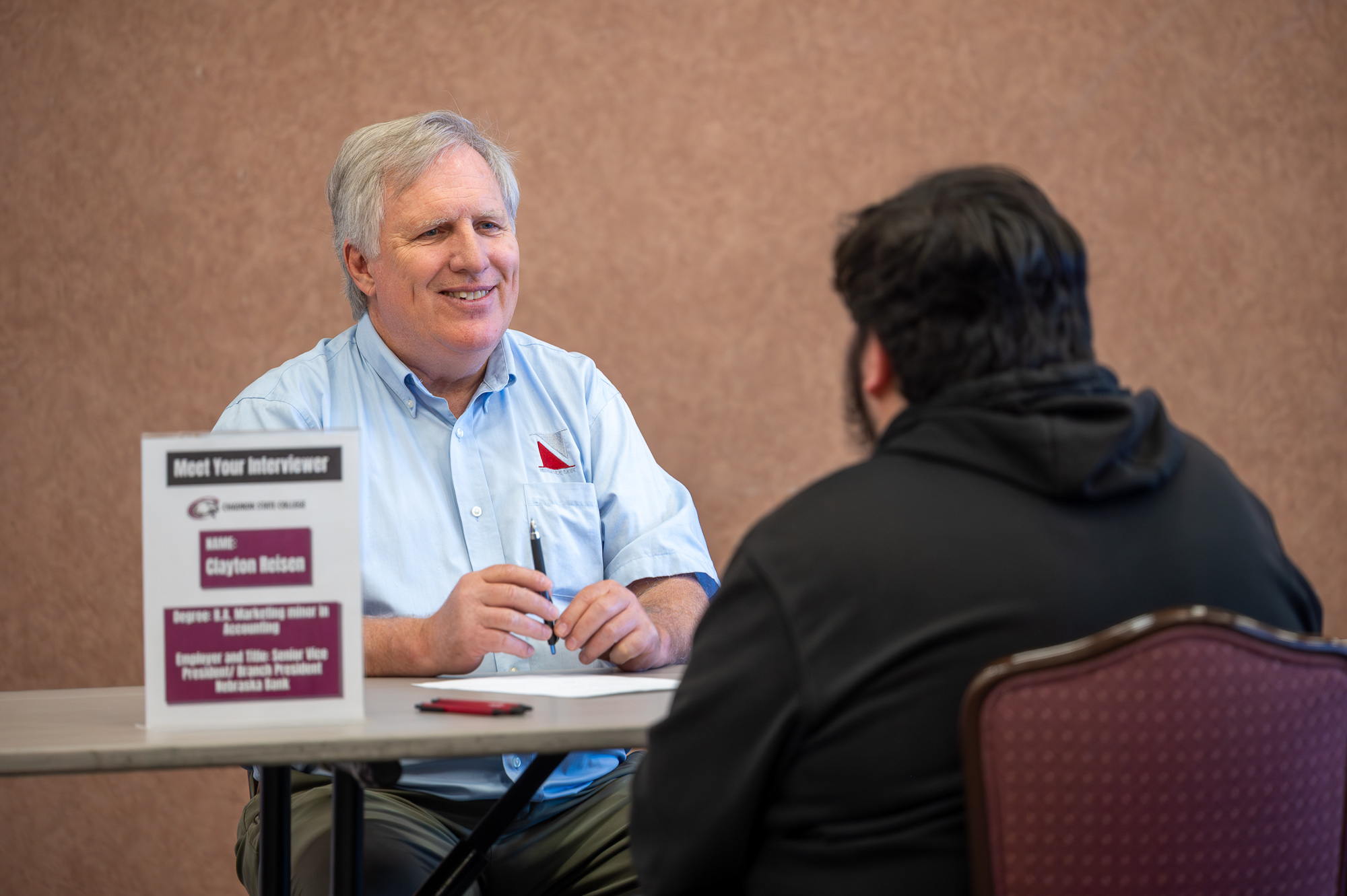 Student practicing interview skills with a community member during the 2026 Speed Interview event.