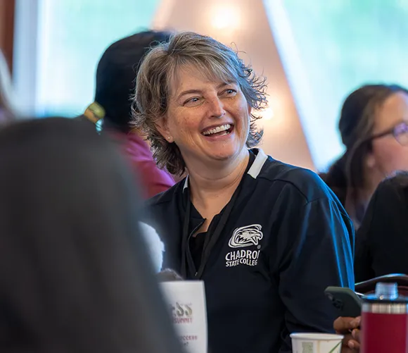 Woman smiling while attending a conference