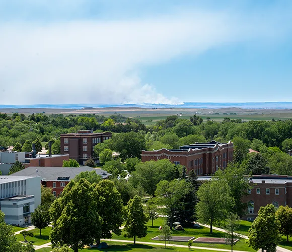College campus from high angle with wildfire smoke in the distant background