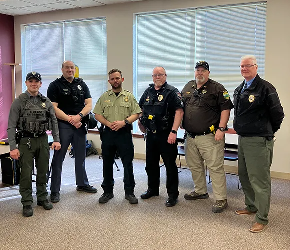 Six law enforcement and security workers posing for a photo