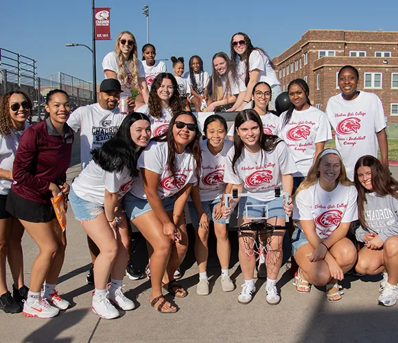 Large group of college students posing for a photo during a parade