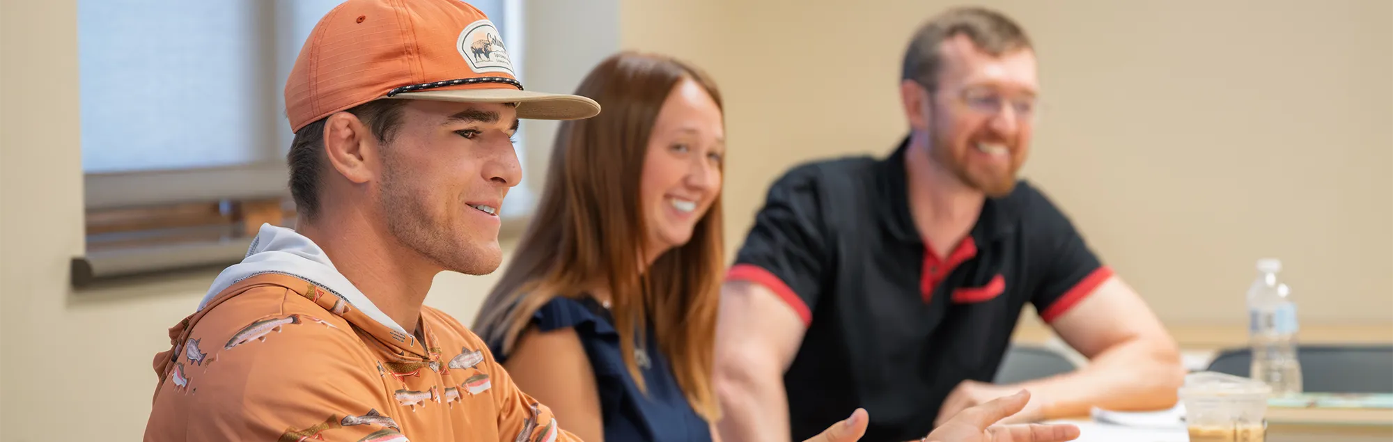 Two students and a professor in a group discussion