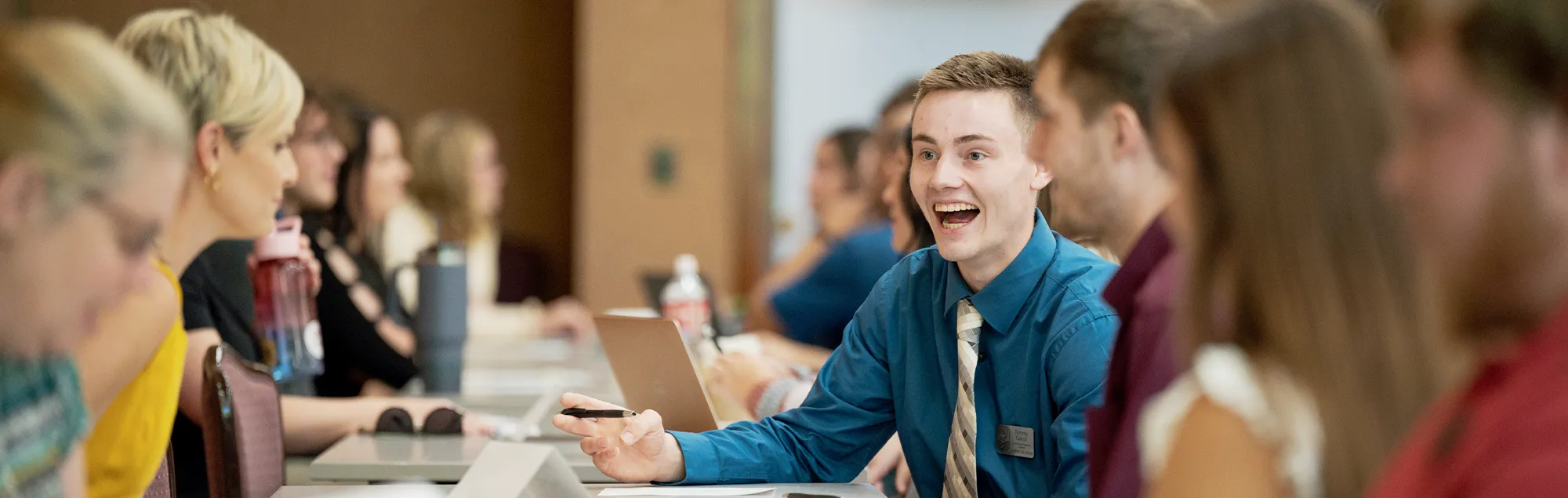 Business students speaking to business professionals at a conference
