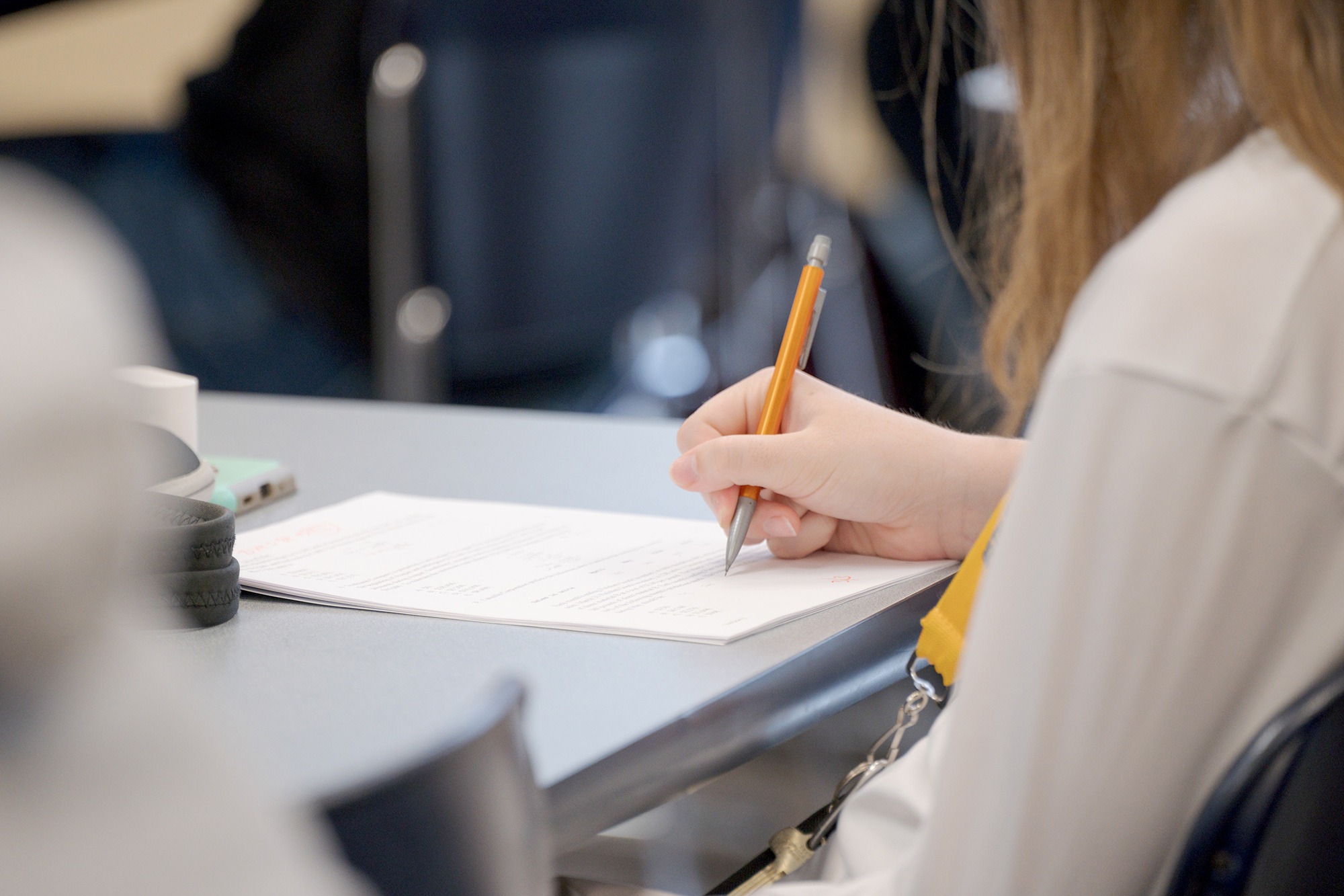 A student writing on a paper test.