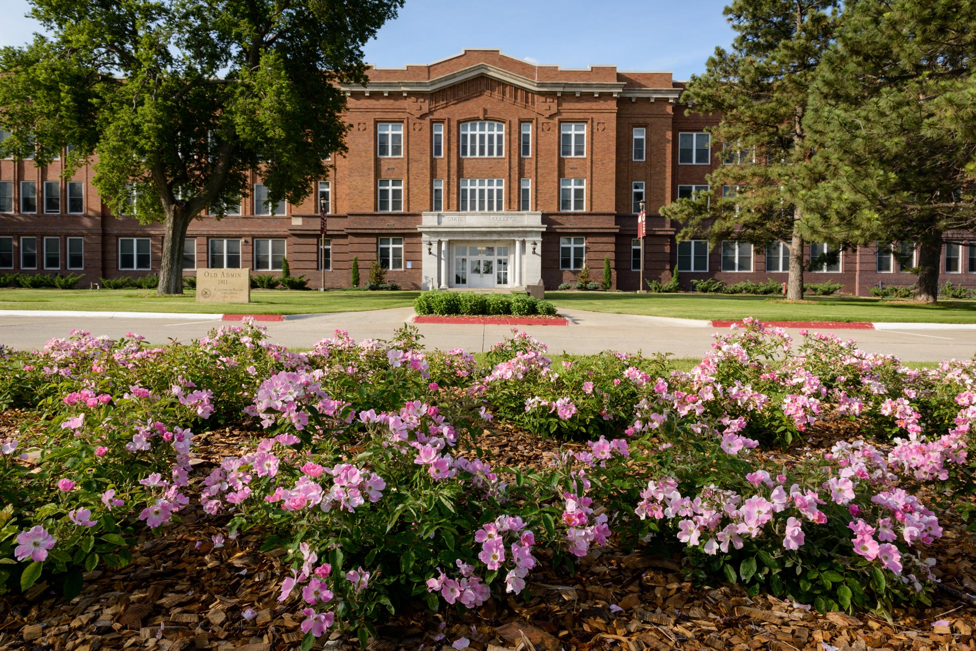 Façade of Old Admin with flowers in the foreground