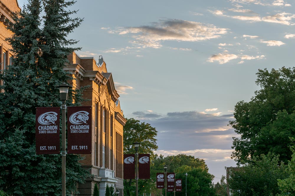 Old Admin façade viewed from an angle with sunset clouds beyond